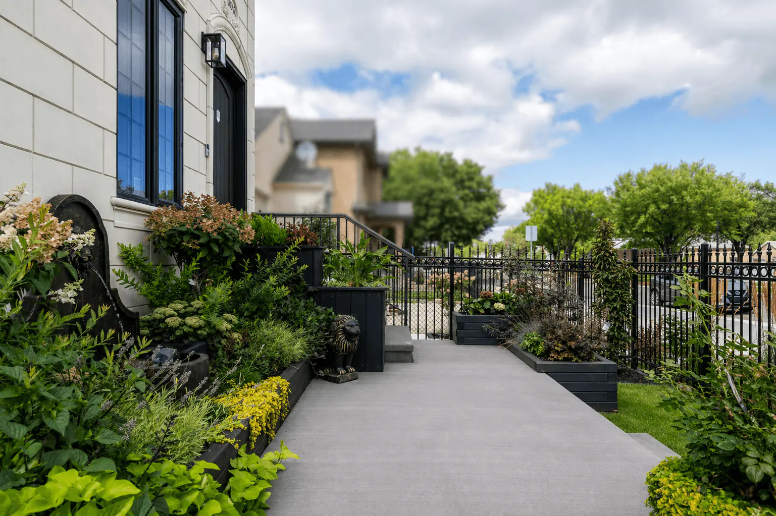 Front garden water fountain and layered planters by Interiors on Main