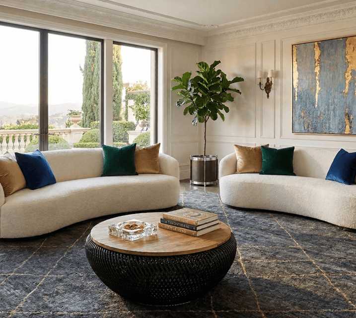 Curved ivory sofas around a dark round table